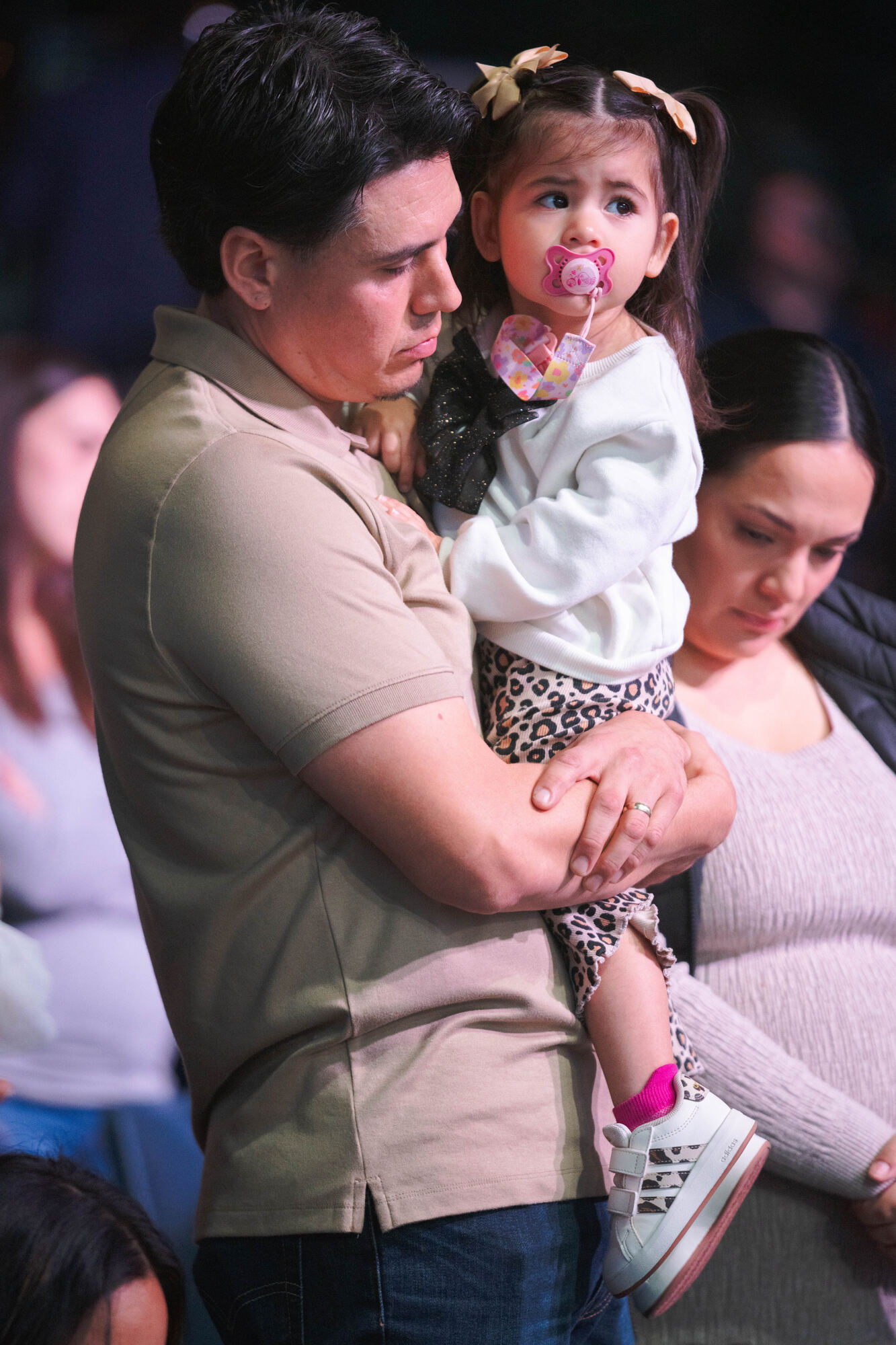 A pastor praying over a child