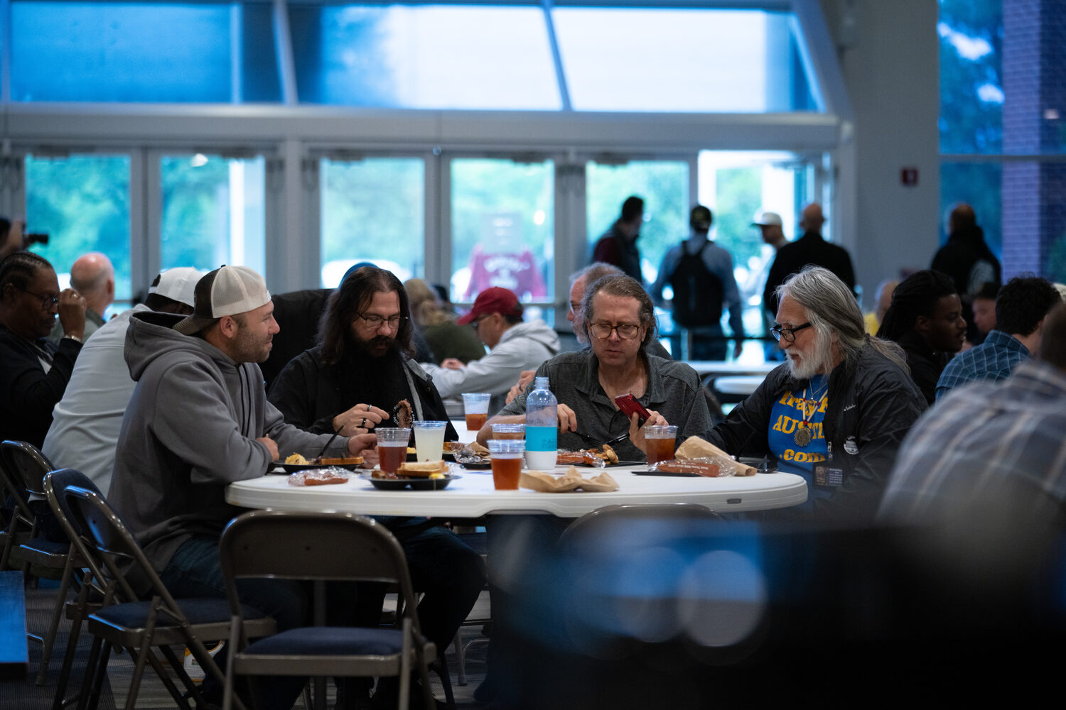 Men talking over BBQ around a table