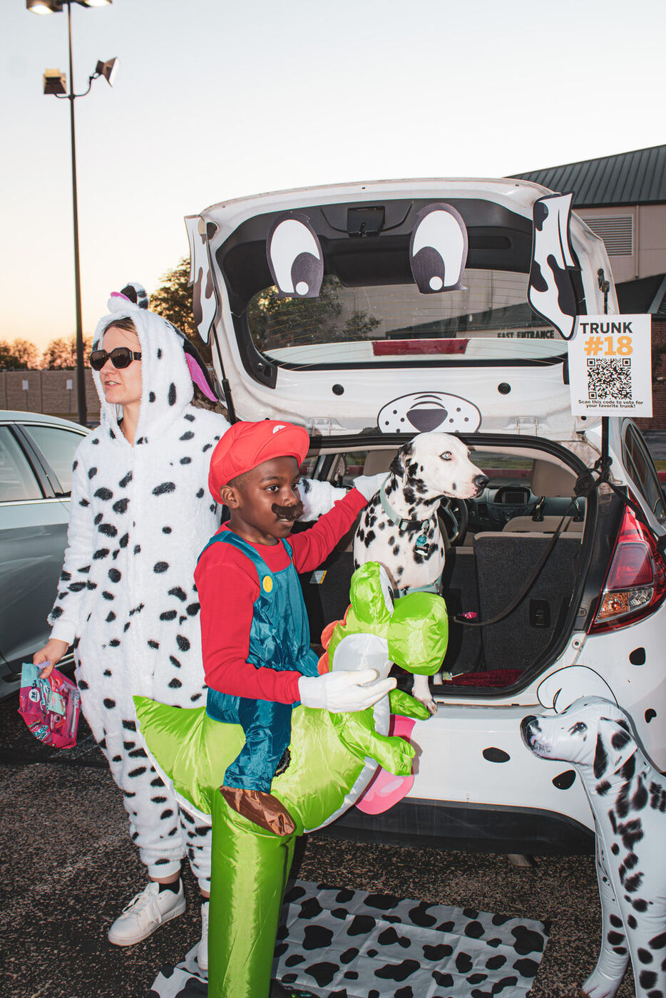 A dalmatian-themed trunk with a real dalmatian in the back