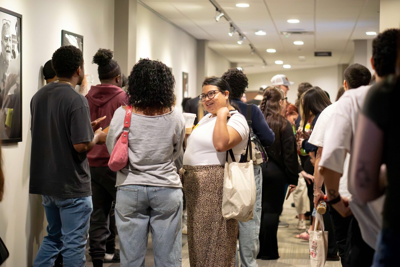 Young adults talking together in the hallway after a Tuesday night