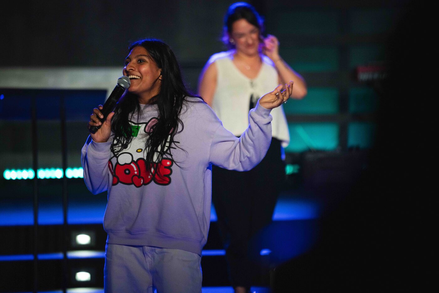 A Young Adults host on stage during a Tuesday night gathering